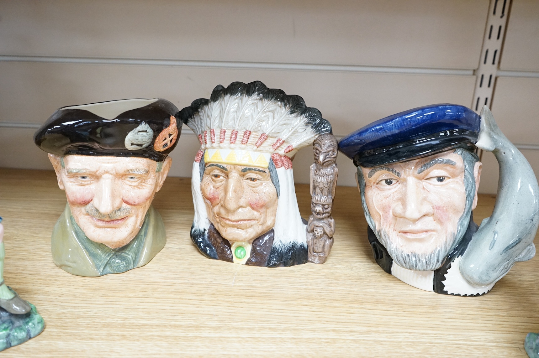 Four Royal Doulton jugs to include ‘Monty’ and two figures comprising ‘The Laird’ and ‘The Piper’, largest 21cm high. Condition - good